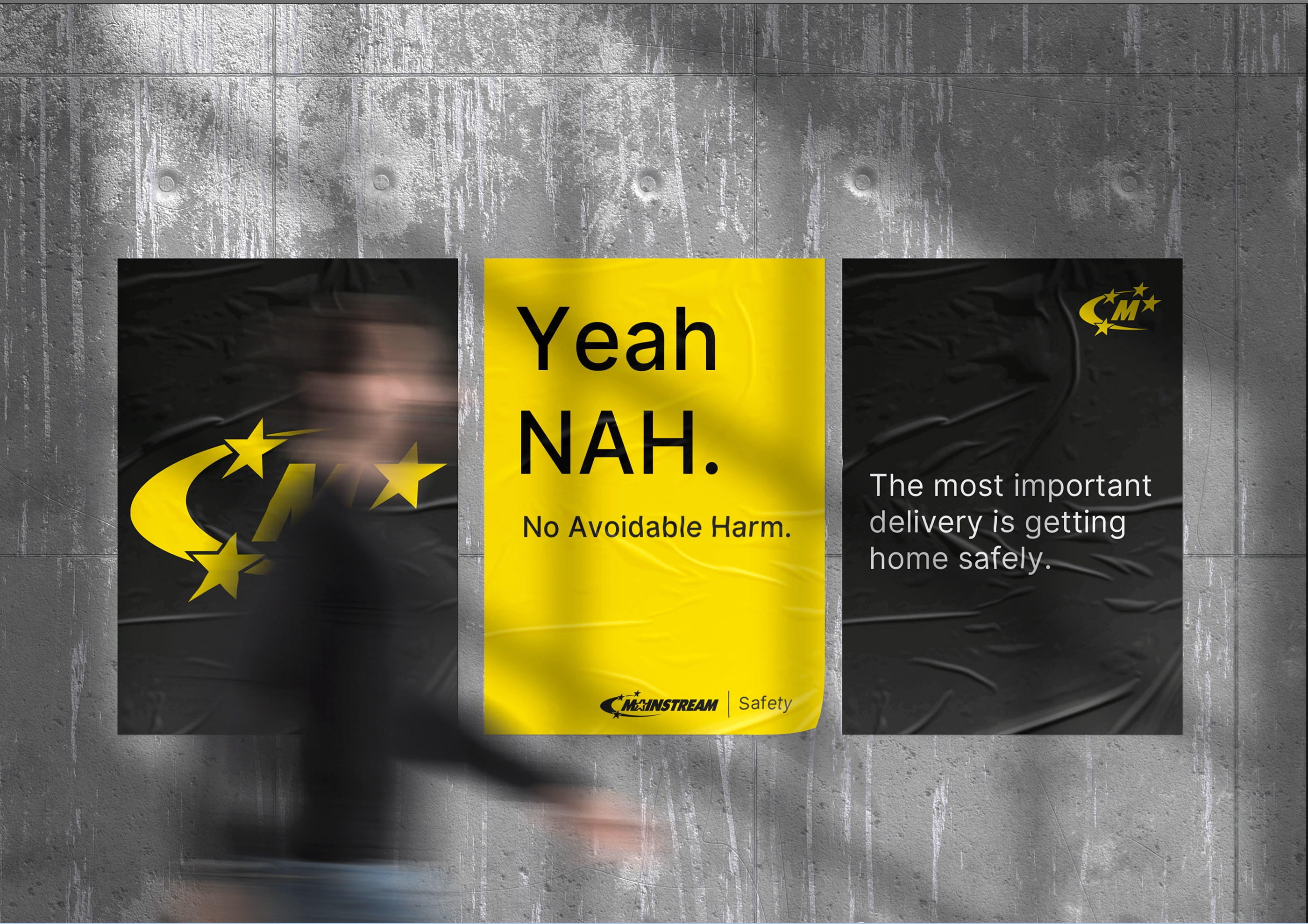 Image of a set of three Mainstream posters with a man walking in-front of them