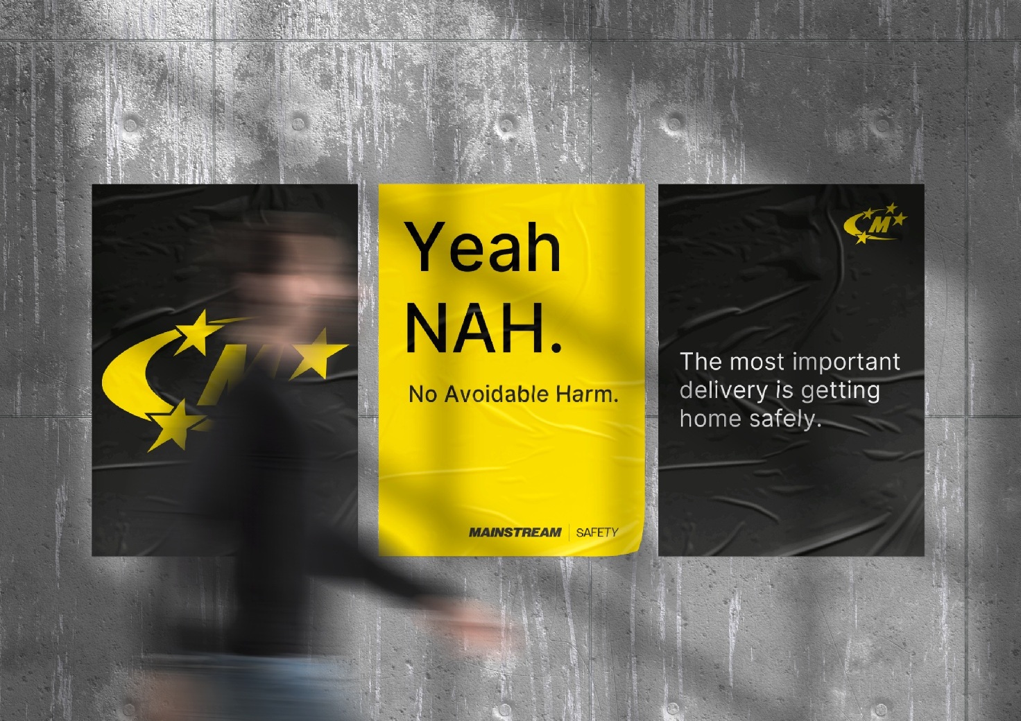 Image of a set of three Mainstream posters with a man walking in-front of them